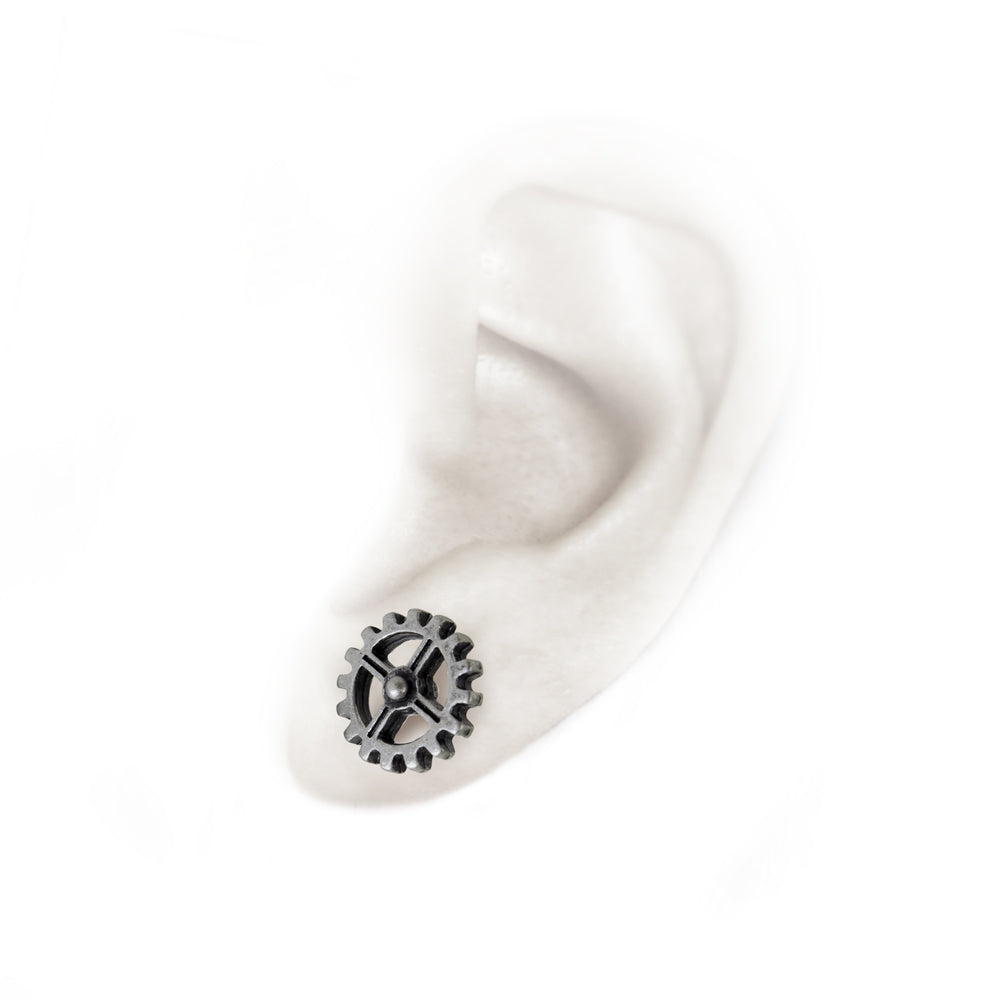 Cogwheel Earrings on a ear
