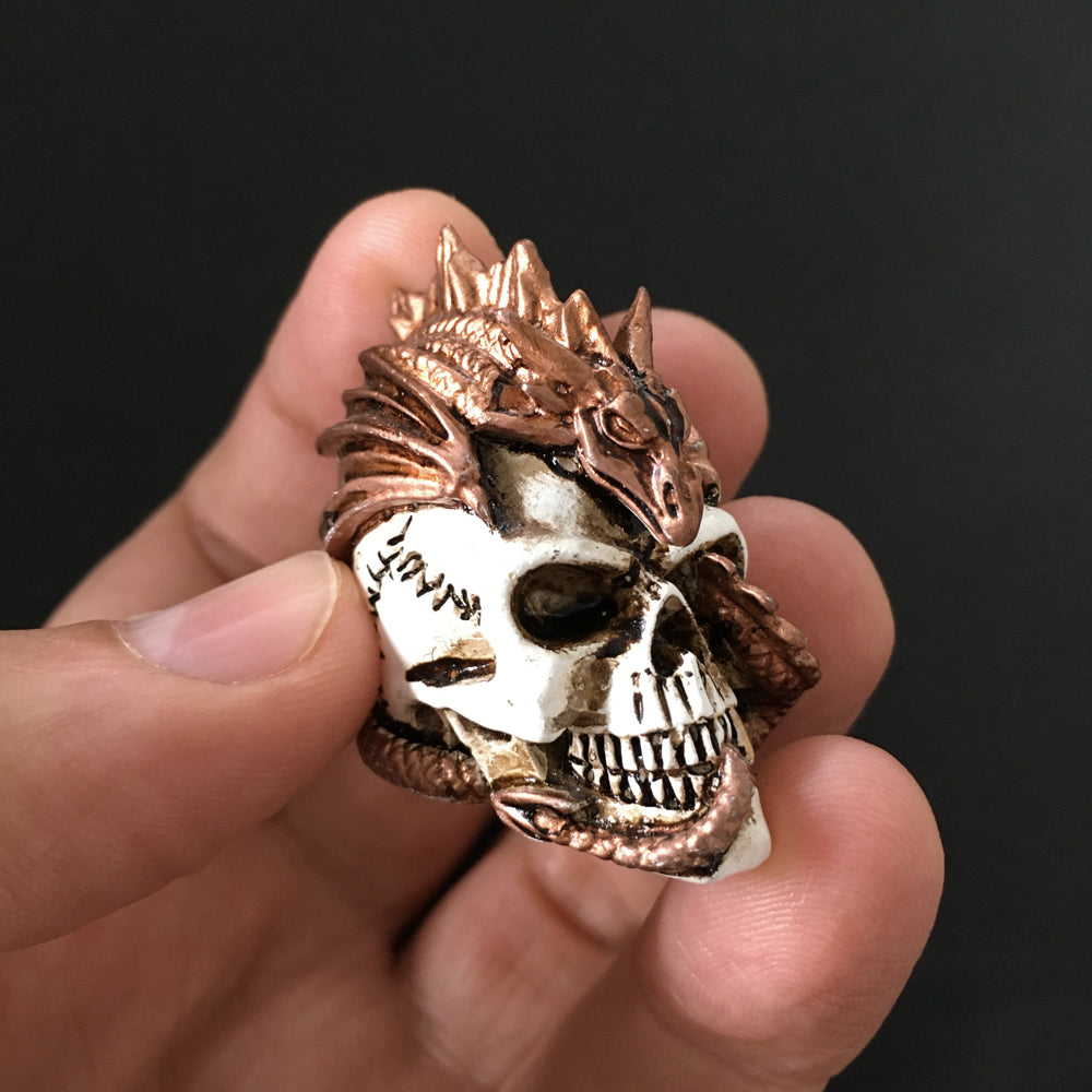 Dragon Keeper Of Skulls Statue holding by a hand