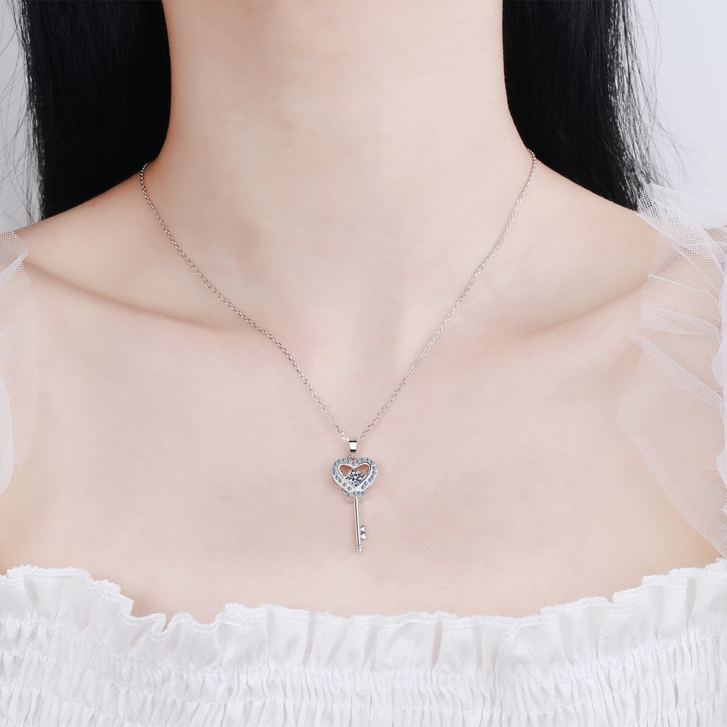 Key And Stone Pendant With A Moissanite Diamond on a woman